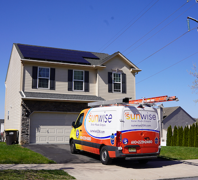 sunwise van in front of picturesque home with new solar system on roof
