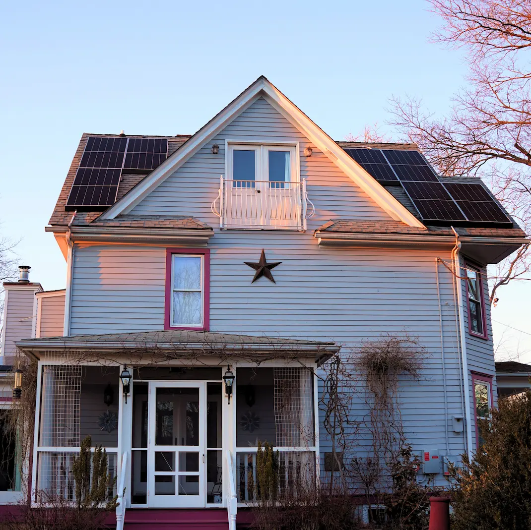 colonial style east coast home slanted steep roof with solar panels