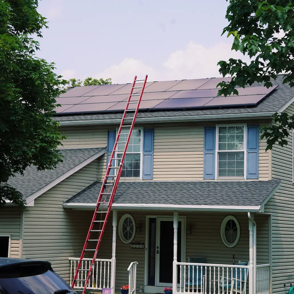 Home with blue shutters and new solar panels white porch
