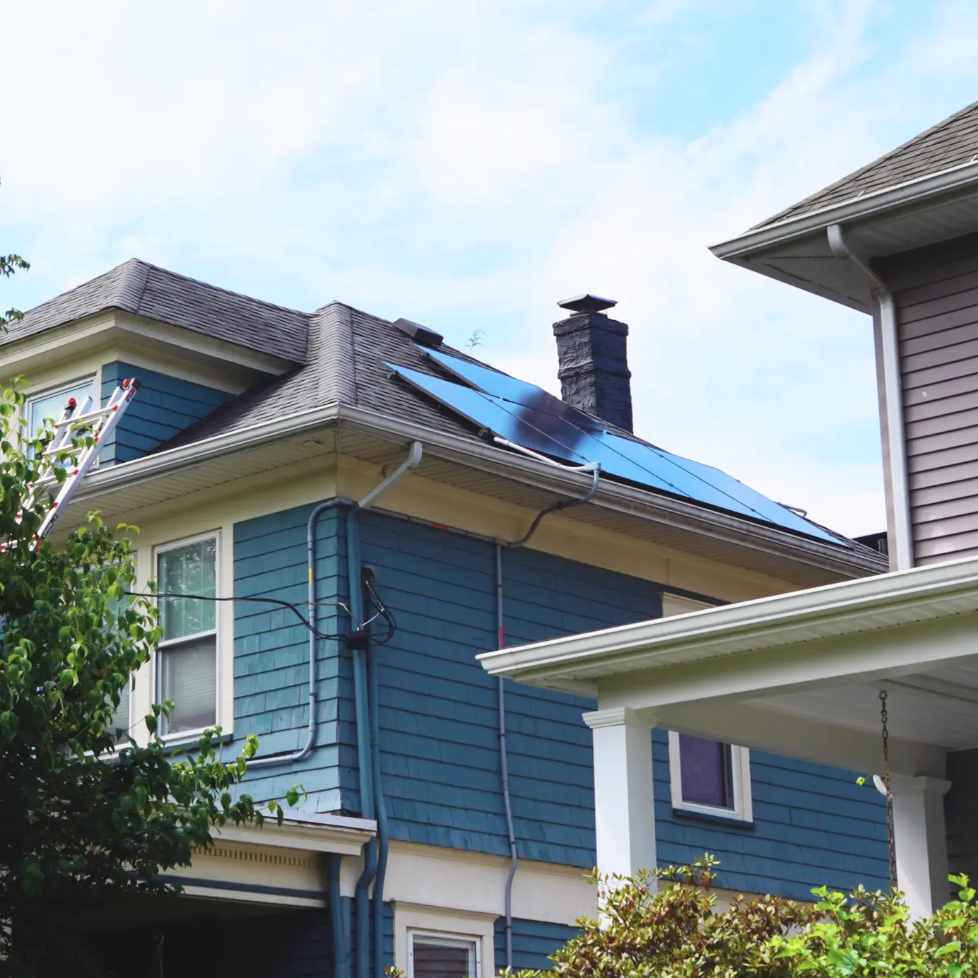 blue east coast home with newly installed solar panels