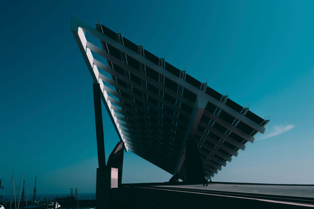 220W bifacial solar panels installed on a modern structure, capturing sunlight from both sides against a clear blue sky.