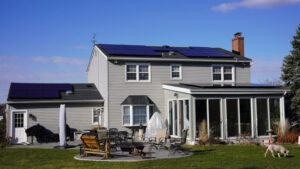 Residential home with REC solar panels installed on the roof, harnessing renewable energy for sustainable living.