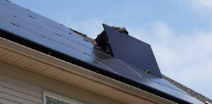 Technician removing a solar panel from the roof of a residential home in New Jersey.