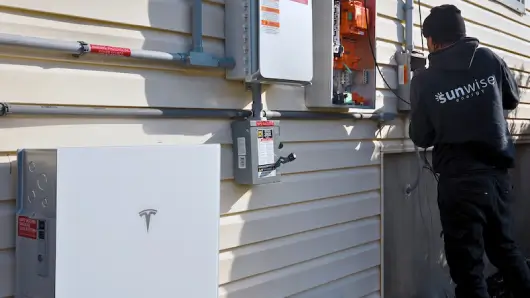 Person installing a battery system