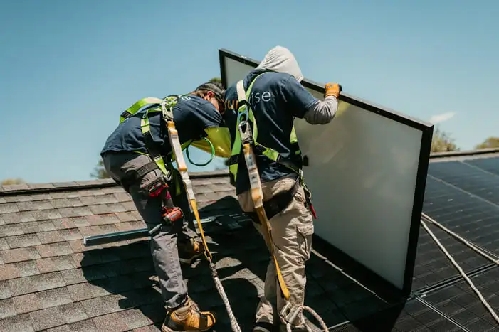 Sunwise Energy installers mounting a solar panel on a residential roof